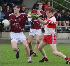 ??  ?? Conor Stafford of St. Martin’s holds off Adam Feery.