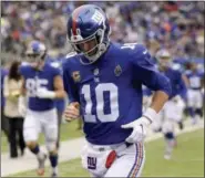  ?? BILL KOSTROUN — THE ASSOCIATED PRESS ?? Giants quarterbac­k Eli Manning runs off the field at the end of the first half of the team’s game against the Washington Redskins in East Rutherford, N.J., on Oct. 28.