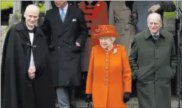  ?? Alastair Grant ?? The Associated Press Queen Elizabeth II and Prince Philip, right, wait for their car after the Christmas Day church service at St. Mary Magdalene Church in Sandringha­m, England.