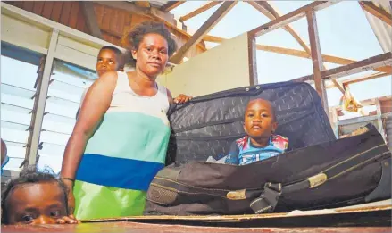  ?? Picture: JOVESA NAISUA ?? Siliva Ditalei shows how she had to protect her three-year-old son Josese Vola by putting him in a suitcase at the height of STC Yasa that ravaged the island of Kia last week.