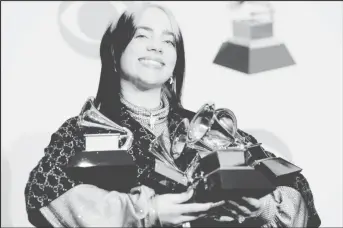  ??  ?? Billie Eilish posing backstage with her awards (REUTERS/Monica Almeida)