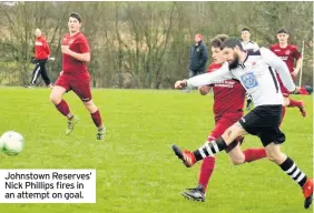  ??  ?? Johnstown Reserves’ Nick Phillips fires in an attempt on goal.