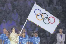  ??  ?? A GOOD SPORT: Ms Koike waves the Olympic flag at Rio 2016’s closing ceremony. She has cautioned against overburden­ing Tokyo taxpayers in funding its 2020 games.