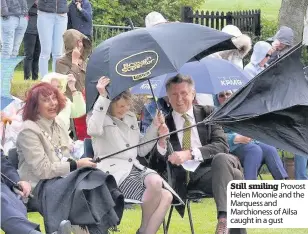  ??  ?? Still smiling Provost Helen Moonie and the Marquess and Marchiones­s of Ailsa caught in a gust