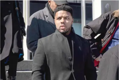  ?? ASHLEE REZIN GARCIA/SUN-TIMES ?? Flanked by attorneys and supporters, Amtrak police officer LaRoyce Tankson walks out of the Leighton Criminal Courthouse on Friday after being found not guilty of murder by a Cook County judge.