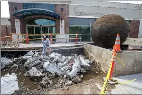  ?? NWA Democrat-Gazette/J.T. WAMPLER ?? Sergio Flores of Springdale uses a saw to cut iron rebar Wednesday while demolishin­g the front stairs at the Town Center on the Fayettevil­le square. The center just wrapped an interior renovation to increase its rentable space, adopted a new website and has plans for several upcoming events, among other recent efforts its staff has undertaken. The city is installing new stairs in front of the building because they sank because of leaking from the World Peace Prayer Fountain.