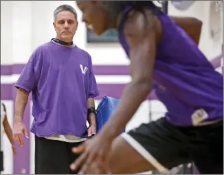  ?? Katharine Lotze/The Signal (See additional photos on signalscv.com) ?? Valencia girls varsity basketball head coach Jerry Mike watches players run shooting drills at practice.