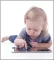  ??  ?? A toddler with a tablet