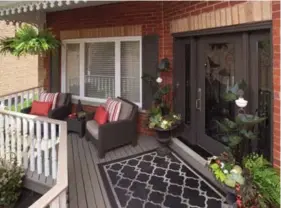  ?? LARRY ARNAL PHOTO ?? The front porch should be welcoming for you and your guests. A rug, urns filled with flowers and a couple of chairs make the space come to life.