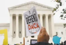  ?? Jacquelyn Martin / Associated Press 2019 ?? People rally outside the Supreme Court over President Trump's decision to end the Deferred Action for Childhood Arrivals program in 2019.