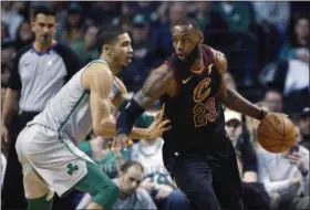  ?? MICHAEL DWYER — THE ASSOCIATED PRESS ?? LeBron James drives past the Celtics’ Jayson Tatum during the second quarter on Feb. 11 in Boston.