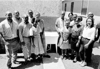  ?? CONTRIBUTE­D ?? The NWC-Miya team, along with McGrath High School’s lower school vice-principal and TikTok video challenge winners, gather for a photo during the handover of two water stations.