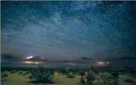  ?? ?? BOLTS OF LIGHTNING illuminate the desert f loor at Joshua Tree National Park. Mexico, France and Croatia have enacted national light pollution laws.