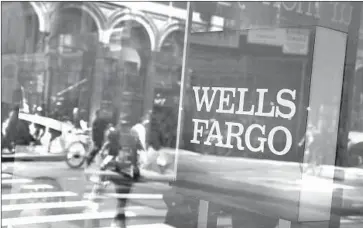  ?? Spencer Platt Getty Images ?? WELLS FARGO reported third-quarter revenue of $21.9 billion, topping analysts’ prediction of $21.8 billion.