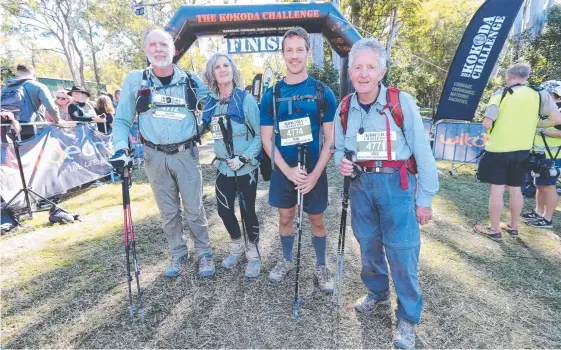  ?? Pictures: MIKE BATTERHAM ?? Gold Coast Bushwalkin­g Club members (from left) Wayne Sendall, 72, Rhonda Walters, 71, Ryan Whitehead, 30, and Greg Mather, 72, at the finish of the Kokoda Challenge at Nerang yesterday and (below) Gold Coast Suns’ inaugural CEO Travis Auld (right) was among 2300 hikers.