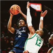  ?? Craig Mitchelldy­er / Associated Press ?? UConn’s Tristen Newton, left, shoots against Oregon forward Quincy Guerrier on Thursday.