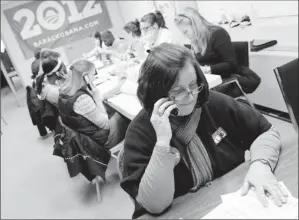  ?? By Eileen Blass, USA TODAY ?? Early start: Ellen Roy works the phones at the Obama campaign headquarte­rs in Manchester, N.H. The campaign has seven field offices in the only swing state in generally Democratic New England.