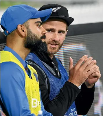  ?? PHOTOSPORT ?? New Zealand captain Kane Williamson chats with Indian skipper Virat Kohli when both sat out the final Twenty20 internatio­nal on Sunday. Williamson will again be watching on from the sidelines when the 50-over series starts today.