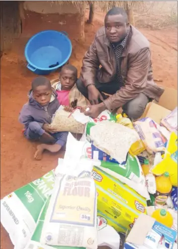  ??  ?? ZANU-PF National House Assembly candidate for Chivi South Cde Killer Zivhu poses for a photograph with the Sigauke brothers after donating groceries and offering the boys’ father a job