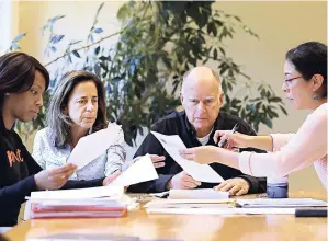  ?? AP ?? California Governor Jerry Brown reviews a measure with his wife, Anne Gust Brown (second left) and staff members Camille Wagner (left) and Graciela Castillo-Krings (right) at his Capitol office on Sunday, September 30, in Sacramento, California.