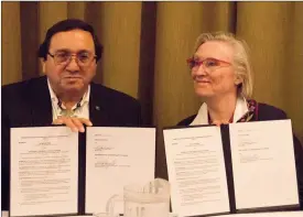  ?? Herald photo by Greg Bobinec ?? Crown-Indigenous Relations and Northern Affairs Minister Carolyn Bennett, right and Blood Tribe Chief Roy Fox show the signing of a Memorandum of Understand­ing Thursday afternoon.