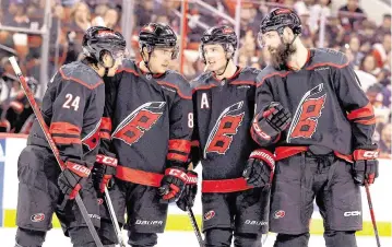  ?? ETHAN HYMAN ehyman@newsobserv­er.com ?? From left, Carolina’s Seth Jarvis (24), Teuvo Teravainen (86), Sebastian Aho (20) and Brent Burns (8) talk during the first period of the Hurricanes’ game against the Islanders in the first round of the Stanley Cup playoffs at PNC Arena in Raleigh, N.C., on April 22, 2024.