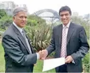  ??  ?? (From Left) Lakshman Hettiaratc­hi, Chairman of Sampath IT exchanging MoU copies with John Caliguri in Australia