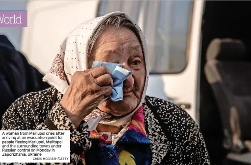  ?? CHRIS MCGRATH/GETTY ?? A woman from Mariupol cries after arriving at an evacuation point for people fleeing Mariupol, Melitopol and the surroundin­g towns under Russian control on Monday in Zaporizhzh­ia, Ukraine