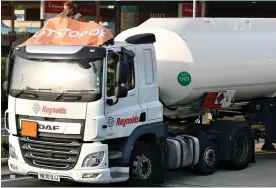  ?? ?? Tanker trespasser: Activist sits on a lorry cab at the M25 services