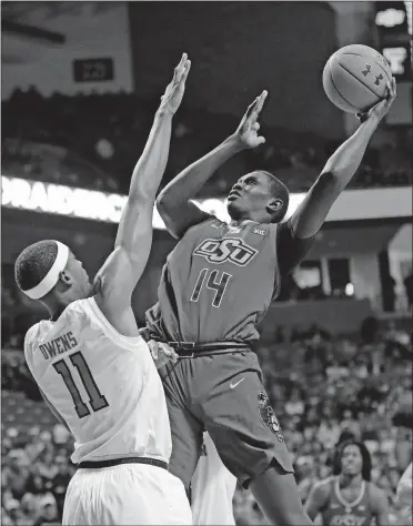  ?? [BRAD TOLLEFSON/THE ASSOCIATED PRESS] ?? Oklahoma State's Yor Anei (14) shoots over Texas Tech's Tariq Owens (11) during the Red Raiders 84-80 win Wednesday night in Lubbock, Texas.