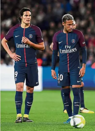  ?? — AFP ?? Strained relationsh­ip: Paris St Germain forwards Edinson Cavani (left) and Neymar deciding on who will take the penalty in the Ligue 1 match against Lyon at the Parc des Princes on Sunday.