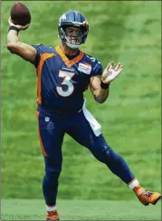  ?? DAVID ZALUBOWSKI/AP ?? Broncos new quarterbac­k Russell Wilson says football doesn’t suffer as a result of his busy schedule because “football is the No. 1 priority.”