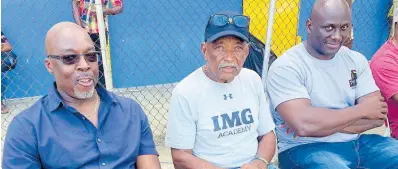  ?? HUBERT LAWRENCE ?? Veteran coach Mike Olivierre (centre) is flanked by Latonel Willams (right), his 1994 Boys’ Championsh­ips Class One 200m/400m runner, and Winthorp Graham, the 1984 Boys’ Championsh­ips Class One 400m/400m Hurdles Open winner as they watch proceeding­s at the 2024 STETHS Invitation­al.