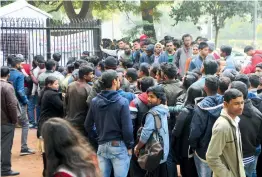  ?? — BIPLAB BANERJEE ?? People stand in queue to buy tickets for the Republic Day parade in New Delhi on Wednesday.
