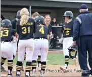  ?? Photo by Dane Fuelling ?? Peyton Pries is greeted at home by her teammates after hitting the go-ahead home run Friday to beat Bellmont. Pries finished the game 1 for 3 with two runs scored and two RBI.