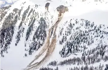  ?? — AFP photo ?? A general view of an avalanche that swept away four people in Vallon d’Arbi, above the city of Riddes, western Switzerlan­d.