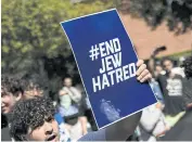  ?? PHOTOS BY AFP ?? A pro-Israeli demonstrat­or holds a poster on the campus of the University of California Los Angeles on Sunday.