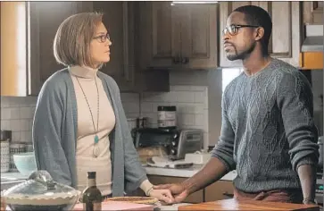  ?? Ron Batzdorff NBC ?? REBECCA (Mandy Moore) is comforted by Randall (Sterling K. Brown) in a Season 4 episode of “This Is Us.”