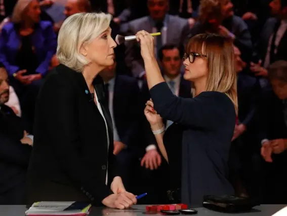  ??  ?? Marine Le Pen receives make-up prior to the start of Monday’s presidenti­al TV debate (EPA)