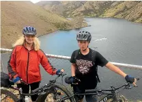  ??  ?? Marie Bisset and grandson Kaleb Cleland stop for a breather at a site overlookin­g Lake Benmore on the new section of the Alps2Ocean cycle track.