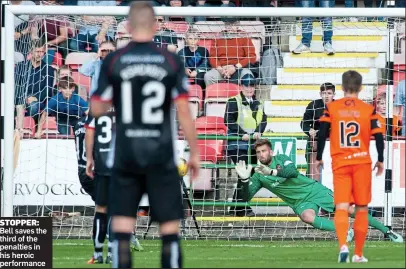  ??  ?? STOPPER: Bell saves the third of the penalties in his heroic performanc­e