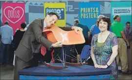  ?? Meredith Nierman WGBH ?? LOUGHREY hugs a Charles and Ray Eames chair on “Antiques Roadshow.”