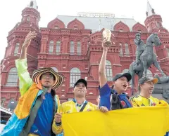  ?? EPA ?? Colombian fans cheer with a replica World Cup trophy at the State Historical Museum near Red Square in Moscow.