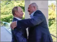  ?? (File Photo/AP/Sputnik/Kremlin/Pool/Gavriil Grigorov) ?? Russian President Vladimir Putin (left) and Lukashenko greet each other Sept. 26 during their meeting in the Bocharov Ruchei residence in the Black Sea resort of Sochi, Russia.