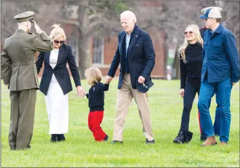  ?? ?? US First Lady Jill Biden and President Joe Biden hold hands with grandson Beau Biden, holding a small egg for Easter, followed by son Hunter Biden, and his wife Melissa, as they are saluted after exiting the Marine One helicopter on landing at Fort McNair, on March 31 in Washington, upon return from Camp David. (AP)
