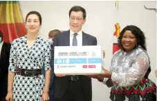  ?? ?? First Lady Dr Auxillia Mnangagwa receives a consignmen­t of Sinopharm doses from the Ambassador of China to Zimbabwe Guo Shaochun (centre) while his wife, Wang Wei, looks on during the handover ceremony at State House in Harare yesterday