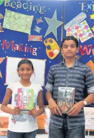  ??  ?? Siblings Maria and Chris Thomas with their books after completing the Lancashire Reading Trail at Accrington Library