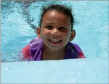  ??  ?? Alyssa Reed, 5, of Lansdale, swims in Mermaid Lake’s pool at the Montgomery County Unity in Community Day.