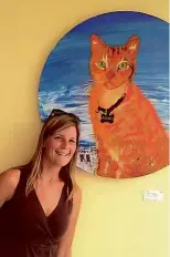  ??  ?? BELOW: Baltimore estate agent Joy Sushinsky with a portrait of Killer the cat.