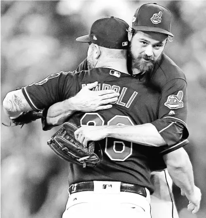  ?? JOHN E. SOKOLOWSKI, USA TODAY SPORTS ?? Reliever Andrew Miller, right, hugging Mike Napoli, has struck out 21 batters this postseason.